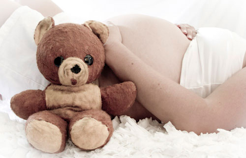 Pregnant women with teddy bear