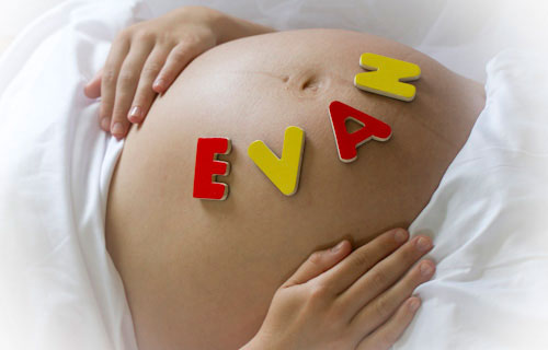 Pregnant belly with EVAN block letters